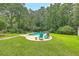 Lush backyard featuring a pool, patio area, and mature trees at 133 Axtell Dr, Summerville, SC 29485