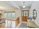 Inviting foyer featuring hardwood floors, wooden table, decorative mirror, and stylish light fixture at 133 Axtell Dr, Summerville, SC 29485