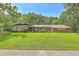 Beautiful brick home featuring a manicured lawn, mature trees, and a welcoming entrance at 133 Axtell Dr, Summerville, SC 29485