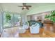 Inviting sunroom with hardwood floors, comfy seating, and ample natural light at 133 Axtell Dr, Summerville, SC 29485
