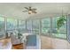 Bright sunroom with large windows offering scenic views, ceiling fan, and comfortable seating at 133 Axtell Dr, Summerville, SC 29485
