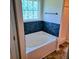White soaking tub with decorative tile backsplash and window, next to a shower stall at 133 Pelican Lane, Summerville, SC 29485