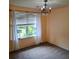 Bright bedroom featuring a decorative chandelier, large window with blinds, and neutral carpeting at 133 Pelican Lane, Summerville, SC 29485