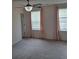 Bedroom featuring light carpet, windows with curtains, and a ceiling fan at 133 Pelican Lane, Summerville, SC 29485