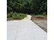 Paved community path with picnic tables on either side, leading through a green wooded area at 133 Pelican Lane, Summerville, SC 29485