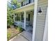 Inviting front porch with white railing, overhead lighting, and decorative details at 133 Pelican Lane, Summerville, SC 29485