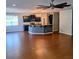 Open-concept kitchen with dark cabinets, granite countertops, and stainless steel appliances at 133 Pelican Lane, Summerville, SC 29485