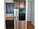 Modern kitchen with stainless steel appliances, dark cabinets, and granite countertops at 133 Pelican Lane, Summerville, SC 29485