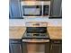 Close up of a black kitchen range and microwave with granite countertops at 133 Pelican Lane, Summerville, SC 29485