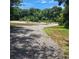 Well-maintained parking area surrounded by mature trees, with a red pickup truck in view at 133 Pelican Lane, Summerville, SC 29485