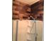 Close-up of the shower with wooden accent wall at 133 Pelican Lane, Summerville, SC 29485
