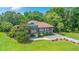 Aerial view of brown two-story home surrounded by green lawns and mature trees at 1343 Headquarters Plantation Dr, Johns Island, SC 29455