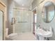 Modern bathroom featuring glass shower, white tile, and pedestal sink at 1343 Headquarters Plantation Dr, Johns Island, SC 29455