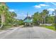 Gated community entrance featuring meticulously landscaped grounds and mature trees at 1343 Headquarters Plantation Dr, Johns Island, SC 29455
