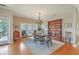 Bright dining room featuring hardwood floors, a chandelier, a wooden dining table, and access to the outdoor deck at 1343 Headquarters Plantation Dr, Johns Island, SC 29455