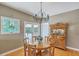 Cozy dining area featuring a round wooden table, chandelier lighting, and vintage wooden furniture at 1343 Headquarters Plantation Dr, Johns Island, SC 29455