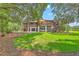 Back exterior featuring a balcony, covered parking, yard, and lush trees at 1343 Headquarters Plantation Dr, Johns Island, SC 29455
