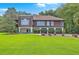 Expansive green lawn leads up to this raised home with great curb appeal at 1343 Headquarters Plantation Dr, Johns Island, SC 29455