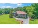 Stunning elevated home with lush landscaping, mature trees, and a circular driveway at 1343 Headquarters Plantation Dr, Johns Island, SC 29455