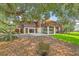 Back of home featuring a car port, wooden deck and mature landscaping at 1343 Headquarters Plantation Dr, Johns Island, SC 29455