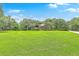 Sprawling green lawn leading to an elegant home surrounded by mature trees at 1343 Headquarters Plantation Dr, Johns Island, SC 29455