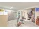 Spacious garage featuring ample storage cabinets, exercise equipment, and an organized golf bag area at 1343 Headquarters Plantation Dr, Johns Island, SC 29455