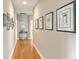 Well-lit hallway with beautiful hardwood floors and decorative framed artwork at 1343 Headquarters Plantation Dr, Johns Island, SC 29455
