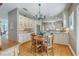 Open kitchen and dining area featuring stainless steel appliances, granite counters, and hardwood flooring at 1343 Headquarters Plantation Dr, Johns Island, SC 29455