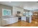 Bright, updated kitchen with white cabinetry, stainless steel appliances, hardwood floors, and ample counter space at 1343 Headquarters Plantation Dr, Johns Island, SC 29455