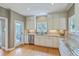 Charming kitchen featuring white cabinetry, stainless steel appliances, granite countertops, and hardwood flooring at 1343 Headquarters Plantation Dr, Johns Island, SC 29455