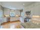 Well-lit kitchen with stainless steel appliances, granite countertops, white cabinets, and a hardwood floor at 1343 Headquarters Plantation Dr, Johns Island, SC 29455
