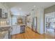 Modern kitchen with stainless steel appliances, granite countertops, white cabinets, wine cooler and hardwood floors at 1343 Headquarters Plantation Dr, Johns Island, SC 29455