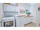 Functional laundry room with modern appliances and ample storage above washer and dryer at 1343 Headquarters Plantation Dr, Johns Island, SC 29455
