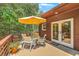 Relaxing patio with an outdoor dining set shaded by an umbrella and mature trees at 1343 Headquarters Plantation Dr, Johns Island, SC 29455