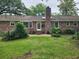 Beautiful backyard featuring a well-maintained lawn, brick exterior, and patio area at 1389 Parkshore Dr, Charleston, SC 29407