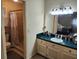 Bathroom with tiled shower, vanity, and a decorative mirror at 1389 Parkshore Dr, Charleston, SC 29407