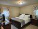 Comfortable bedroom with a large bed, soft lighting, and elegant curtains at 1389 Parkshore Dr, Charleston, SC 29407