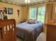 Bright bedroom featuring a comfortable bed, large window, and playful decor accents at 1389 Parkshore Dr, Charleston, SC 29407