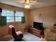 The bedroom has natural light with a gaming chair and TV for relaxing entertainment at 1389 Parkshore Dr, Charleston, SC 29407