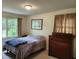 This cozy bedroom offers a comfortable bed, natural light, and a warm, inviting atmosphere at 1389 Parkshore Dr, Charleston, SC 29407