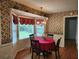 Charming dining area featuring a red table cloth, large windows and a decorative wallpaper at 1389 Parkshore Dr, Charleston, SC 29407