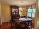Bright dining room with hardwood floors, elegant chandelier, and a classic china cabinet at 1389 Parkshore Dr, Charleston, SC 29407