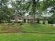 Traditional brick home nestled on a lush lawn with mature trees, exuding charm and curb appeal at 1389 Parkshore Dr, Charleston, SC 29407