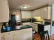 Classic kitchen featuring white cabinets and black appliances in a well-lit space at 1389 Parkshore Dr, Charleston, SC 29407