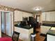 A traditional kitchen with white cabinets, dark green countertops, and black appliances at 1389 Parkshore Dr, Charleston, SC 29407