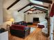 Comfortable living room with wood beams, brick fireplace, and cozy furniture, perfect for relaxation at 1389 Parkshore Dr, Charleston, SC 29407