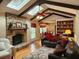 Cozy living room with brick fireplace, wood beams, skylights, and hardwood floors at 1389 Parkshore Dr, Charleston, SC 29407