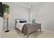 Cozy bedroom featuring a comfortable bed, a lamp and a bright window with plantation shutters at 1460 Oldenburg Dr, Mount Pleasant, SC 29429