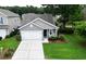 Well-maintained home with a manicured lawn, two car garage, and charming front porch seating at 1460 Oldenburg Dr, Mount Pleasant, SC 29429