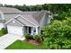 Charming home featuring a manicured lawn, a two car garage, and a cozy front porch with seating at 1460 Oldenburg Dr, Mount Pleasant, SC 29429